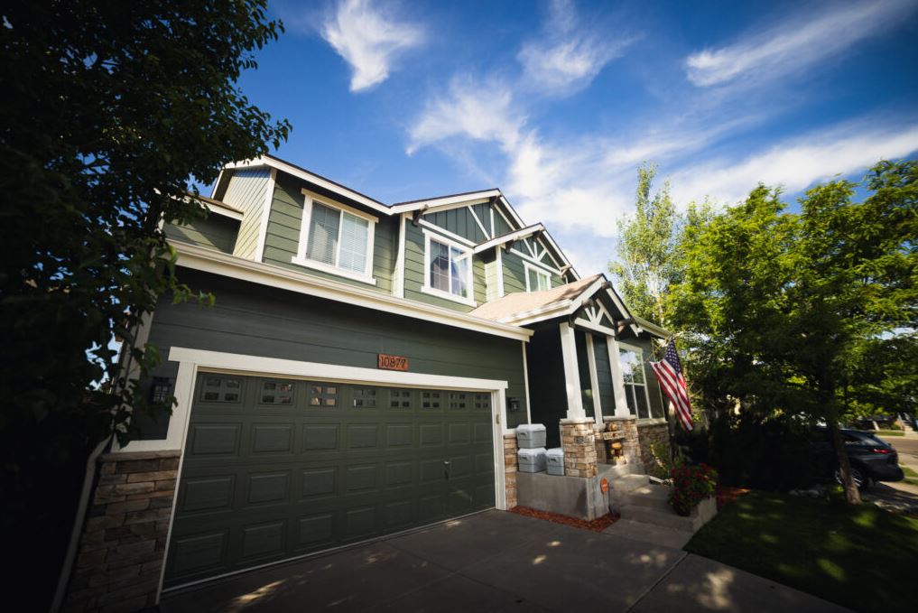 Exterior siding and trim repainted on a suburban Denver home