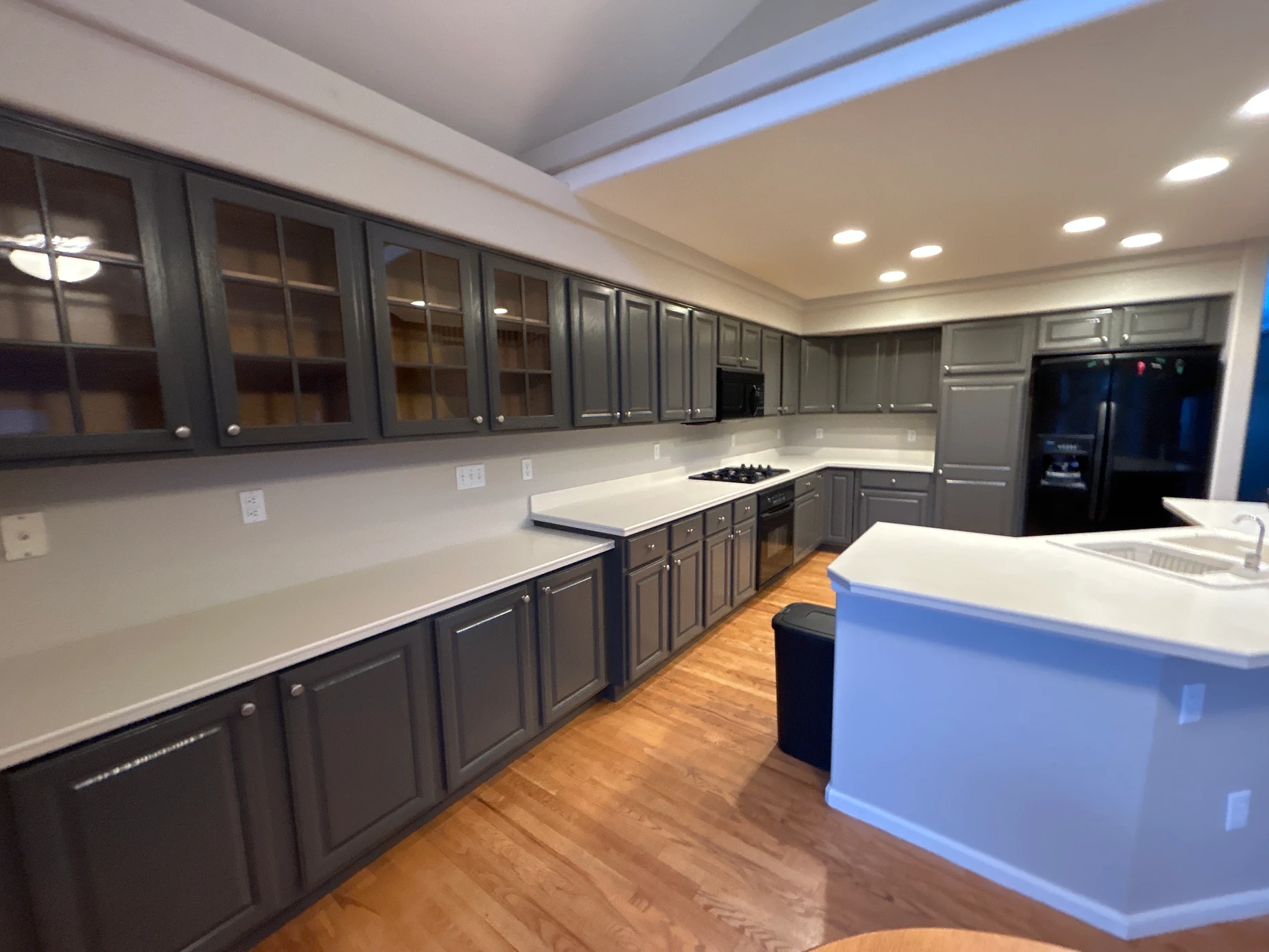 Kitchen cabinets after being painted a soft charcoal grey
