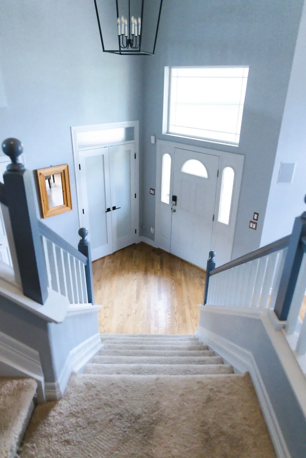 Entry foyer with blue-gray walls and crisp white trim