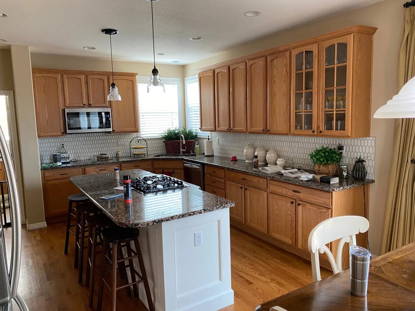 Dated oak kitchen cabinets with granite counters before cabinet painting