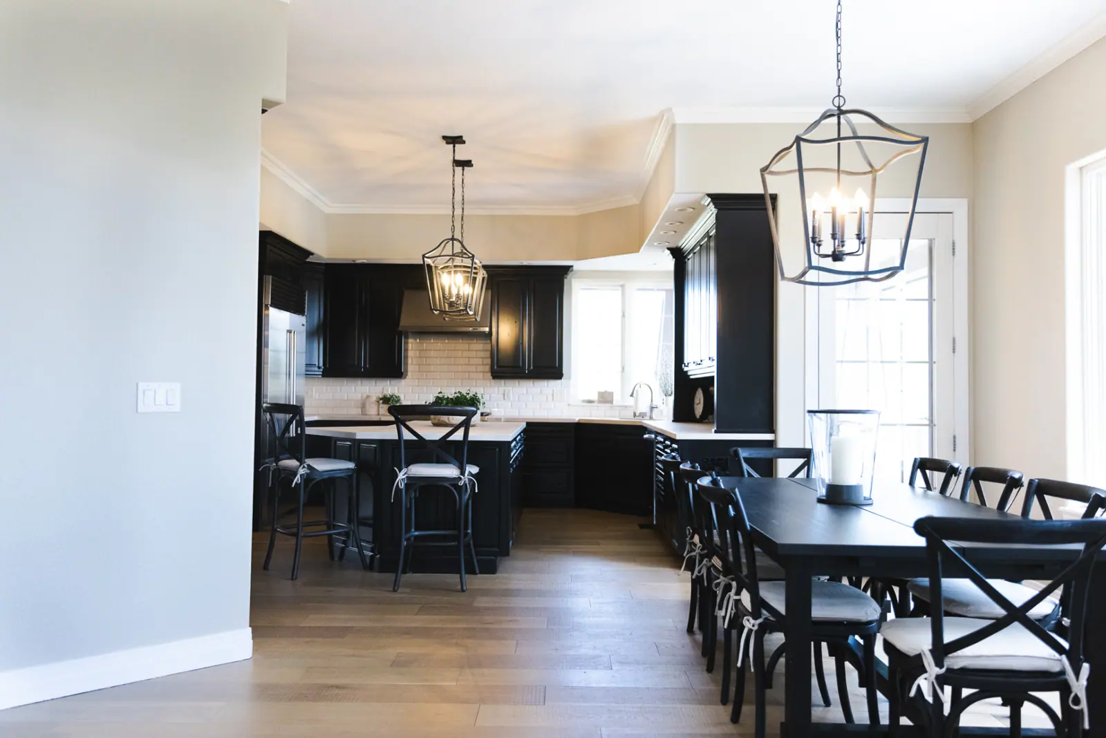 Black painted kitchen cabinetry with white subway tile in Lone Tree
