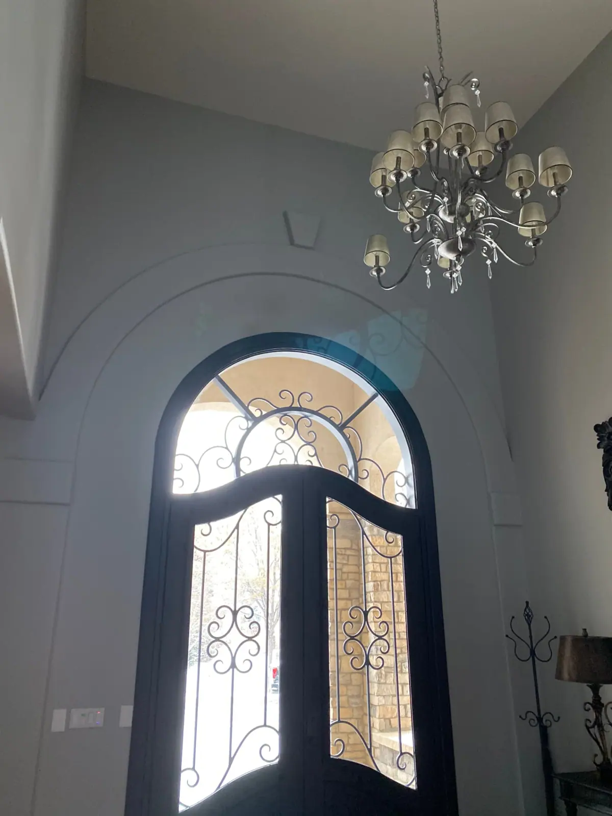Tall entryway with arched glass doors after interior painting in Columbine