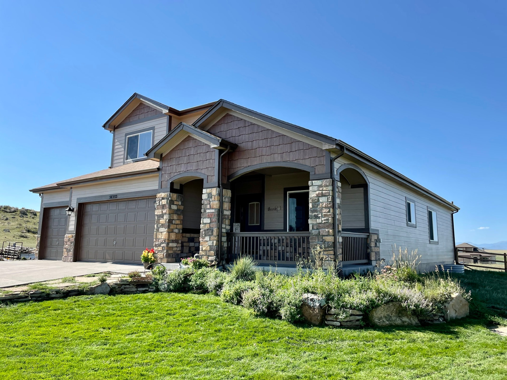 Colorado home exterior after a full repaint in warm neutral tones